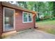 Cozy home exterior featuring a back patio and siding, complemented by lush greenery at 104 Southfork Dr, Woodstock, GA 30189