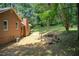 A view of the house's exterior showing the siding and a serene backyard with mature trees at 104 Southfork Dr, Woodstock, GA 30189