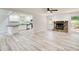 Open-concept living area featuring a stone fireplace and an open view of the modern kitchen at 104 Southfork Dr, Woodstock, GA 30189