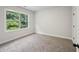 Bright bedroom with a large window view, soft carpeting, and light gray walls at 3131 Stonegate Sw Dr, Atlanta, GA 30331