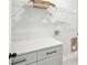 Functional laundry room with gray cabinets and countertop, with white wire rack shelving overhead at 3131 Stonegate Sw Dr, Atlanta, GA 30331