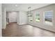 Light-filled living area featuring modern lighting, hardwood floors, and multiple windows providing natural sunlight at 3131 Stonegate Sw Dr, Atlanta, GA 30331