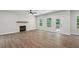 Inviting living area with hardwood floors, a cozy fireplace, and a door leading to outdoor space at 3131 Stonegate Sw Dr, Atlanta, GA 30331