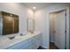 Bright bathroom with dual sinks, sleek mirrors, and a glass-enclosed shower for a modern aesthetic at 428 Whitetail Cir, Canton, GA 30115