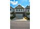 Charming townhome features stone accents, a two-car garage, and professionally landscaped front yard at 428 Whitetail Cir, Canton, GA 30115