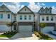Charming townhome features stone accents, a two-car garage, and professionally landscaped front yard at 428 Whitetail Cir, Canton, GA 30115