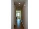 Long hallway with modern laminate flooring and neutral paint, leading to living areas at 428 Whitetail Cir, Canton, GA 30115