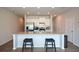 Bright eat-in kitchen featuring a large island with granite countertop, stainless steel appliances and white cabinets at 428 Whitetail Cir, Canton, GA 30115