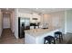 Eat-in kitchen featuring a large island with granite countertop, stainless steel appliances and white cabinets at 428 Whitetail Cir, Canton, GA 30115