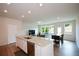 Open-concept kitchen featuring an island with granite countertops and stainless steel appliances at 428 Whitetail Cir, Canton, GA 30115