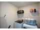 A well-lit laundry room with a modern washer and dryer setup at 428 Whitetail Cir, Canton, GA 30115