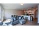 Cozy living room with couch, kitchen and dining area, creating a seamless entertaining space at 428 Whitetail Cir, Canton, GA 30115