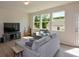Inviting living room area with large windows providing natural light and views of the outdoors at 428 Whitetail Cir, Canton, GA 30115