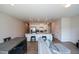 Open-concept living room with a kitchen featuring white cabinets, stainless appliances and a seating area at 428 Whitetail Cir, Canton, GA 30115