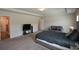 Spacious bedroom with a plush bed, sitting area, and open access to other areas of the house at 428 Whitetail Cir, Canton, GA 30115
