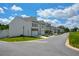 Street view featuring a row of well-maintained townhomes with manicured landscaping at 428 Whitetail Cir, Canton, GA 30115