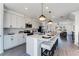 Modern kitchen with a white island, pendant lighting, and views to the living room at 6121 Wayburn St, Tucker, GA 30084