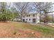 Backyard with mature trees and white two-story home at 1885 N Druid Hills Ne Rd, Atlanta, GA 30319