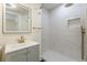 Updated bathroom with walk-in shower, glass door, gray vanity, and modern fixtures at 1885 N Druid Hills Ne Rd, Atlanta, GA 30319