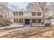 Inviting two-story home featuring a brick facade, a cozy front porch, and a well-manicured front yard at 1885 N Druid Hills Ne Rd, Atlanta, GA 30319