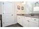Stylish bathroom featuring double sinks, granite countertops, and black fixtures at 2436 Loughridge Dr, Buford, GA 30519
