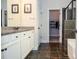Bright bathroom with granite counters, dual sinks, and a walk-in closet with a shower and bathtub at 2436 Loughridge Dr, Buford, GA 30519