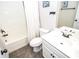 Clean bathroom with a toilet, shower, sink, white cabinets, and mirror at 2436 Loughridge Dr, Buford, GA 30519