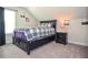 Charming bedroom with a black platform bed, nightstand, and natural light from the window at 2436 Loughridge Dr, Buford, GA 30519