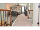 Loft featuring comfortable seating, carpet, lighting, and railing to lower level at 2436 Loughridge Dr, Buford, GA 30519