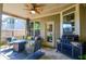 Outdoor covered patio featuring a grill, dining area, and comfortable seating, perfect for relaxing and entertaining at 2436 Loughridge Dr, Buford, GA 30519