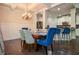 Open-concept dining area with coffered ceilings and a view of the updated kitchen and bar seating at 2436 Loughridge Dr, Buford, GA 30519