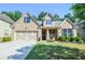Charming brick home featuring a manicured lawn, a two-car garage, and lovely landscaping at 2436 Loughridge Dr, Buford, GA 30519