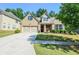 Charming brick home featuring a two-car garage, well-manicured lawn, and inviting curb appeal at 2436 Loughridge Dr, Buford, GA 30519