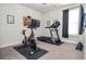 Home gym with exercise bike, weights, tv and treadmill at 2436 Loughridge Dr, Buford, GA 30519