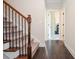Hallway featuring a hardwood floor, staircase and open doorway at 2436 Loughridge Dr, Buford, GA 30519