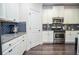 Bright kitchen boasts white cabinets, granite counters, and subway tile backsplash with stainless steel appliances at 2436 Loughridge Dr, Buford, GA 30519
