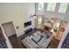 Spacious living room featuring hardwood floors, fireplace, sectional sofa, and large windows at 2436 Loughridge Dr, Buford, GA 30519