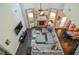 Bright living room featuring hardwood floors, fireplace, sectional sofa, and large windows at 2436 Loughridge Dr, Buford, GA 30519