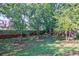 Expansive backyard with mature trees and brick wall at 655 Mead Se St # 3, Atlanta, GA 30312