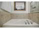 Modern bathtub with chrome hardware and neutral-toned tiled walls, perfect for relaxation at 655 Mead Se St # 3, Atlanta, GA 30312