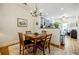 Cozy dining area with a wooden table and chairs, accented by a charming chandelier and view of the kitchen at 655 Mead Se St # 3, Atlanta, GA 30312