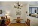 Elegant dining area featuring a wooden table, decorative chandelier and an open view into the kitchen at 655 Mead Se St # 3, Atlanta, GA 30312