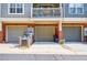 Three-car garage with a brick facade and gray doors, complemented by a balcony above at 655 Mead Se St # 3, Atlanta, GA 30312