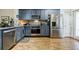 Kitchen featuring stainless steel appliances, wooden floors and gray cabinets at 655 Mead Se St # 3, Atlanta, GA 30312