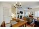 Inviting living room with a fireplace, built-in bookshelves, and a dining area with modern light fixture at 655 Mead Se St # 3, Atlanta, GA 30312