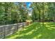 Backyard view with a wood fence providing privacy and defining the property line at 6600 N Beulah Rd, Lithia Springs, GA 30122
