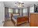 Comfortable bedroom featuring a ceiling fan, carpet, and two windows at 6600 N Beulah Rd, Lithia Springs, GA 30122