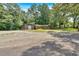 Traditional brick home with mature trees, detached garage and spacious driveway at 6600 N Beulah Rd, Lithia Springs, GA 30122