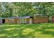 Charming brick ranch home with a lush green lawn and mature trees at 6600 N Beulah Rd, Lithia Springs, GA 30122