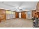 Spacious living room featuring a ceiling fan, wood paneling, and neutral-colored carpet at 6600 N Beulah Rd, Lithia Springs, GA 30122